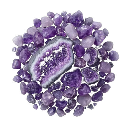 A heaped arrangement of amethyst: raw points, a geode section showing purple druzy, and polished tumbled stones in violet and lilac.