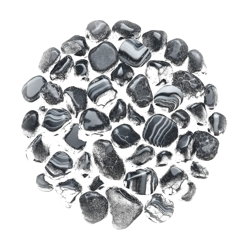 A gathered group of black onyx: polished tumbled stones, a banded slice and carved pieces, flat black with pale banding.